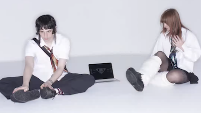 A glitchy image of Ninajirachi and Porter Robison, covered in screens, cursors, and other computer graphical elements.
